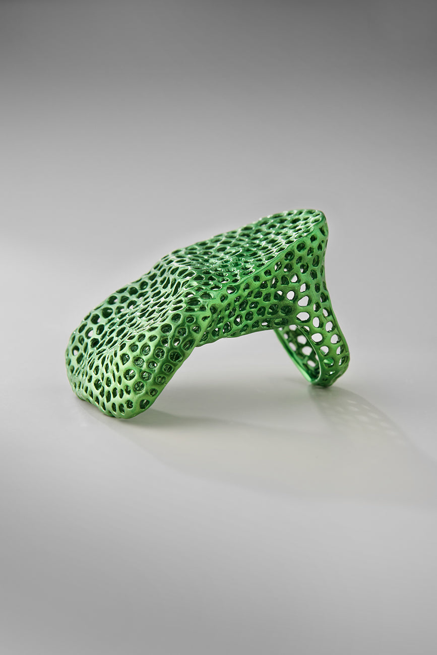 Green textured object on a gray background