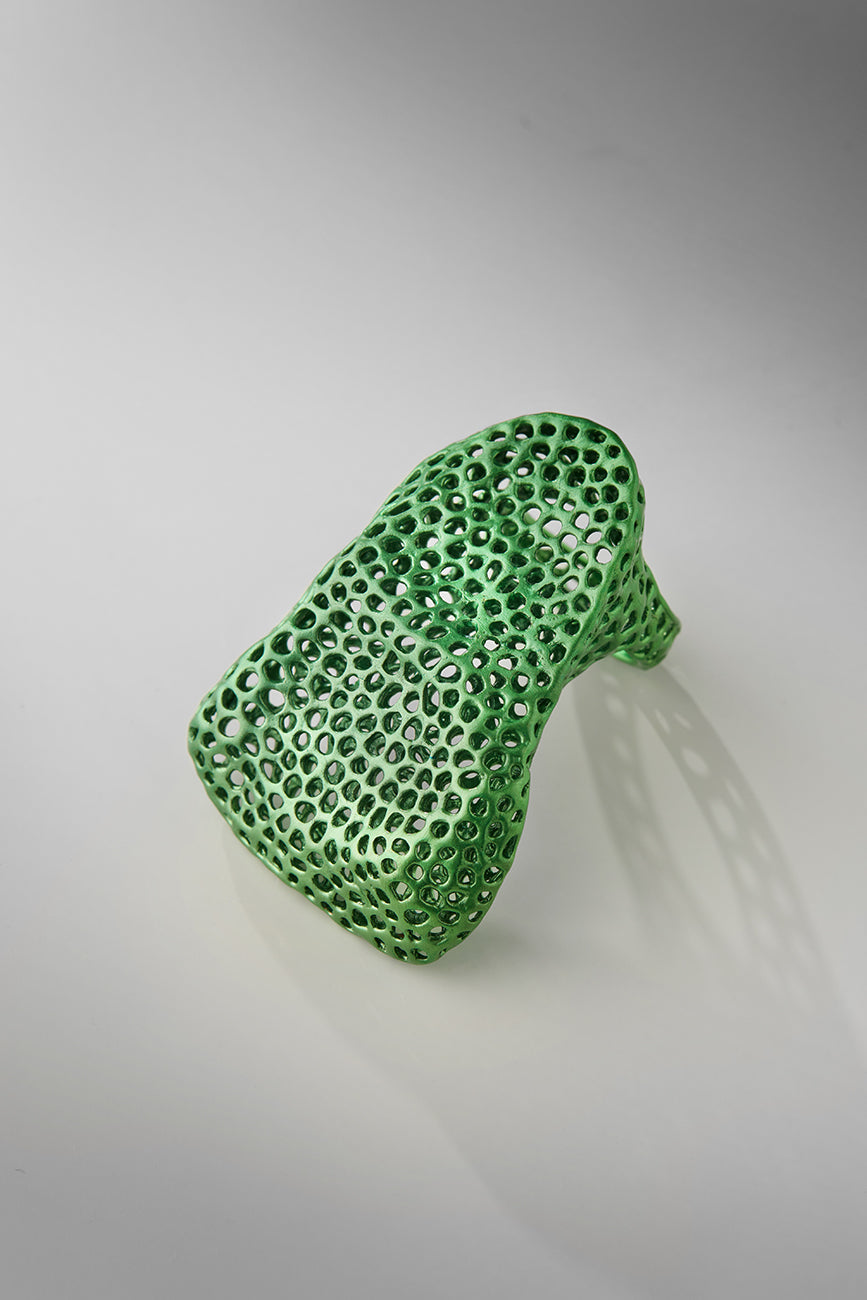 Green textured object on a gray background