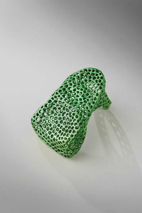 Green textured object on a gray background