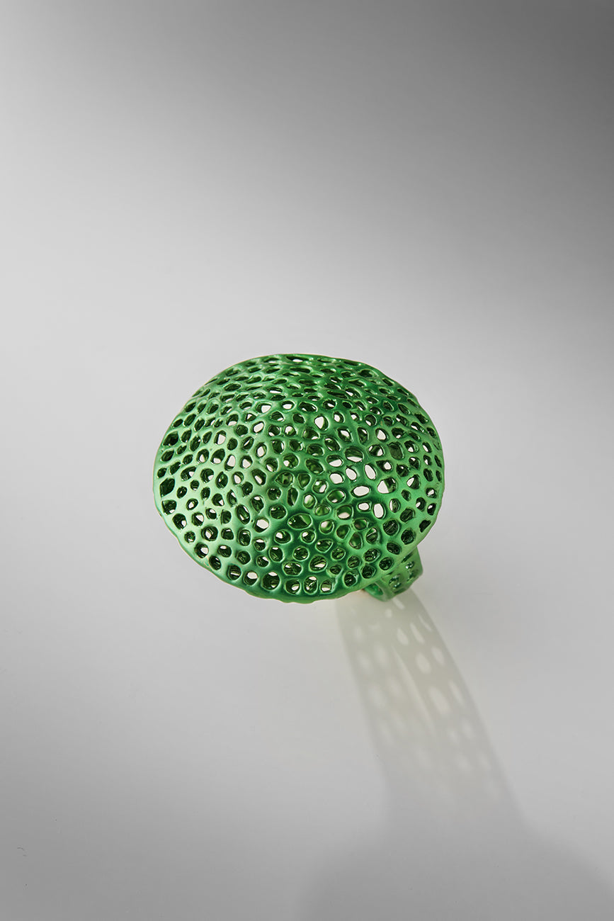 Green textured round ring on a gray background