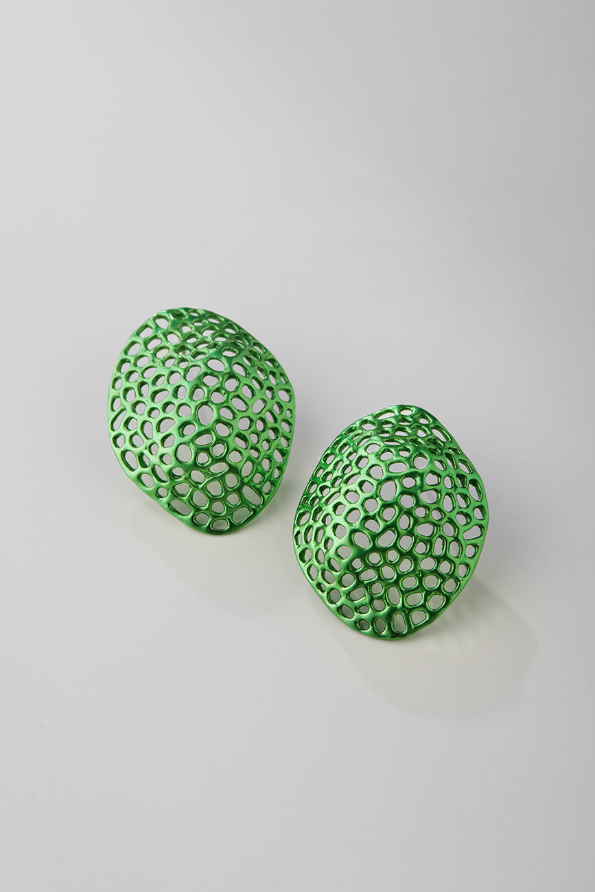 Green earrings with a textured design on a light gray background