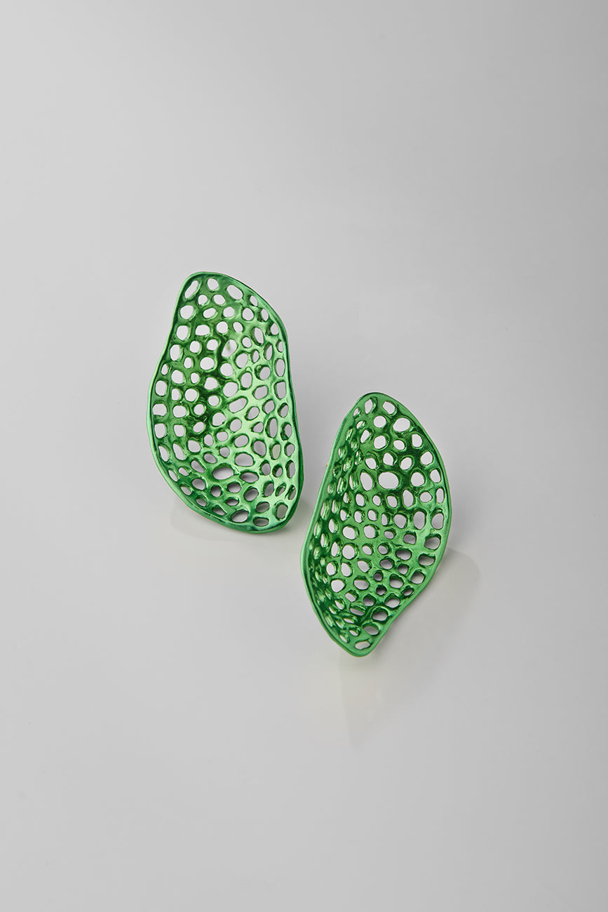Green earrings with a textured, openwork design on a light gray background